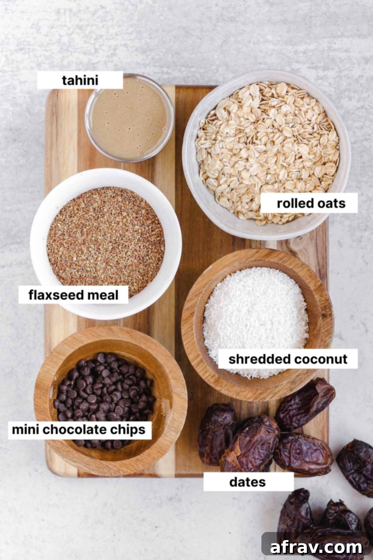 Nut Free Gluten Free Dairy Free Power Bites 3 Clearly labeled ingredients for making nut-free energy balls, including dates, oats, flaxseed meal, tahini, coconut, and mini chocolate chips.