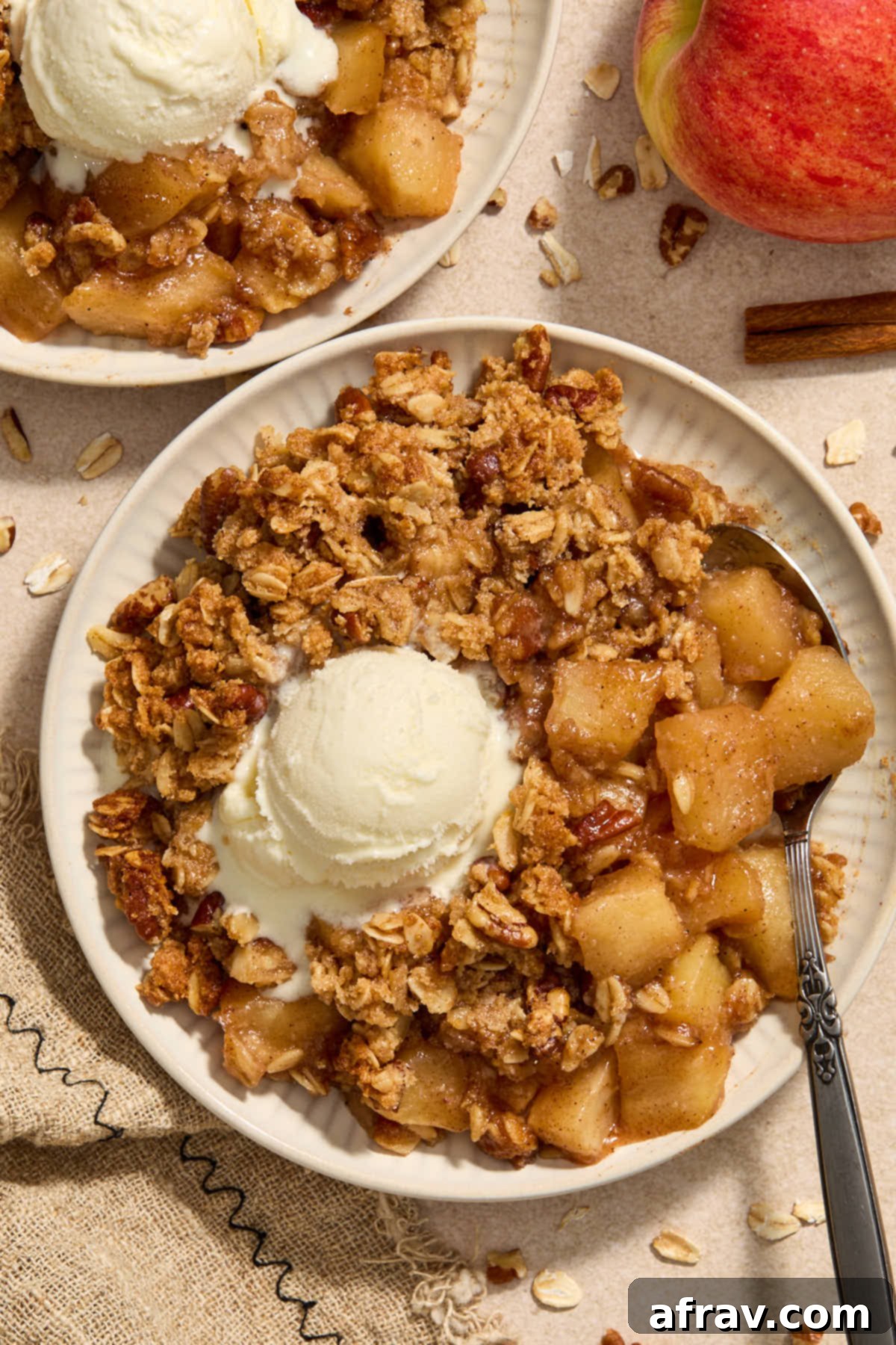 Gluten-Free Almond Flour Apple Pecan Crisp 2 Apple crisp on a plate with vanilla ice cream on top, ready to be enjoyed.