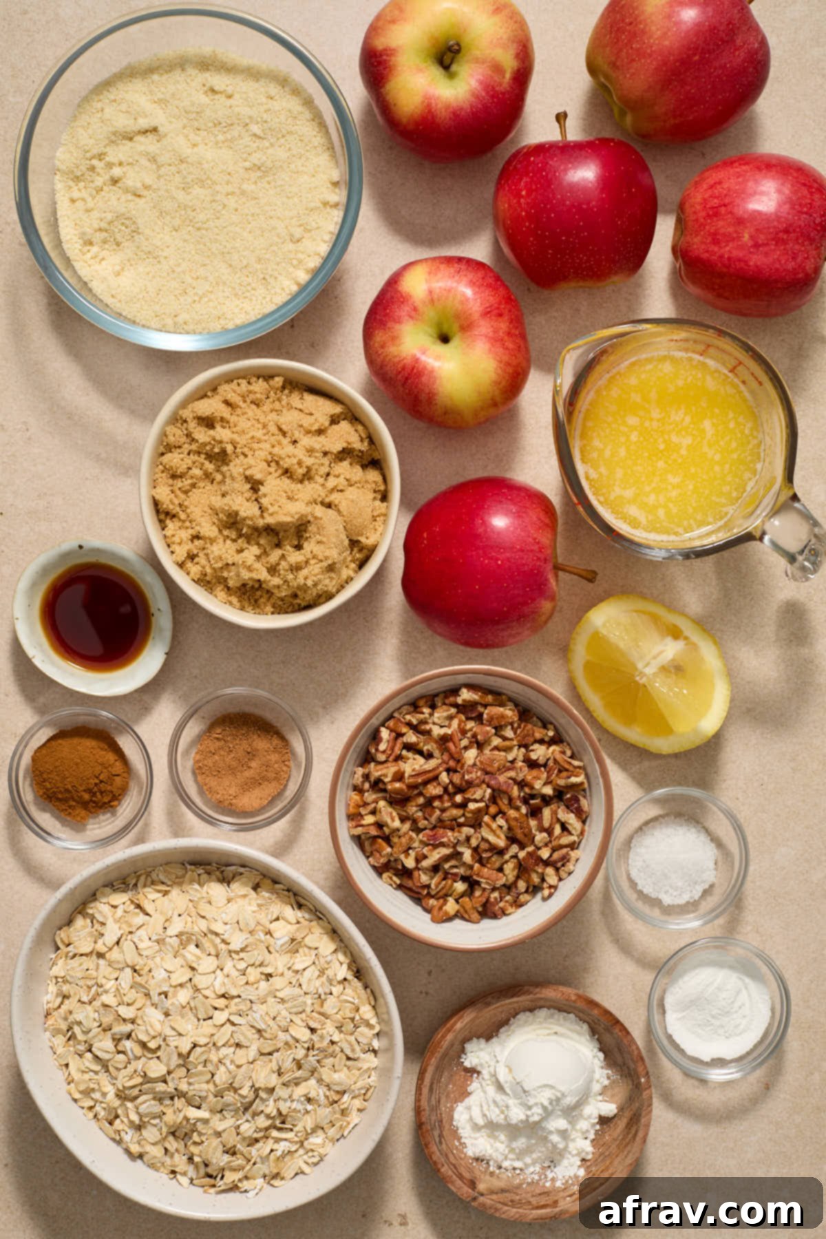 Gluten-Free Almond Flour Apple Pecan Crisp 3 Arrangement of individual ingredients for making apple crisp, including apples, flour, oats, pecans, and spices.