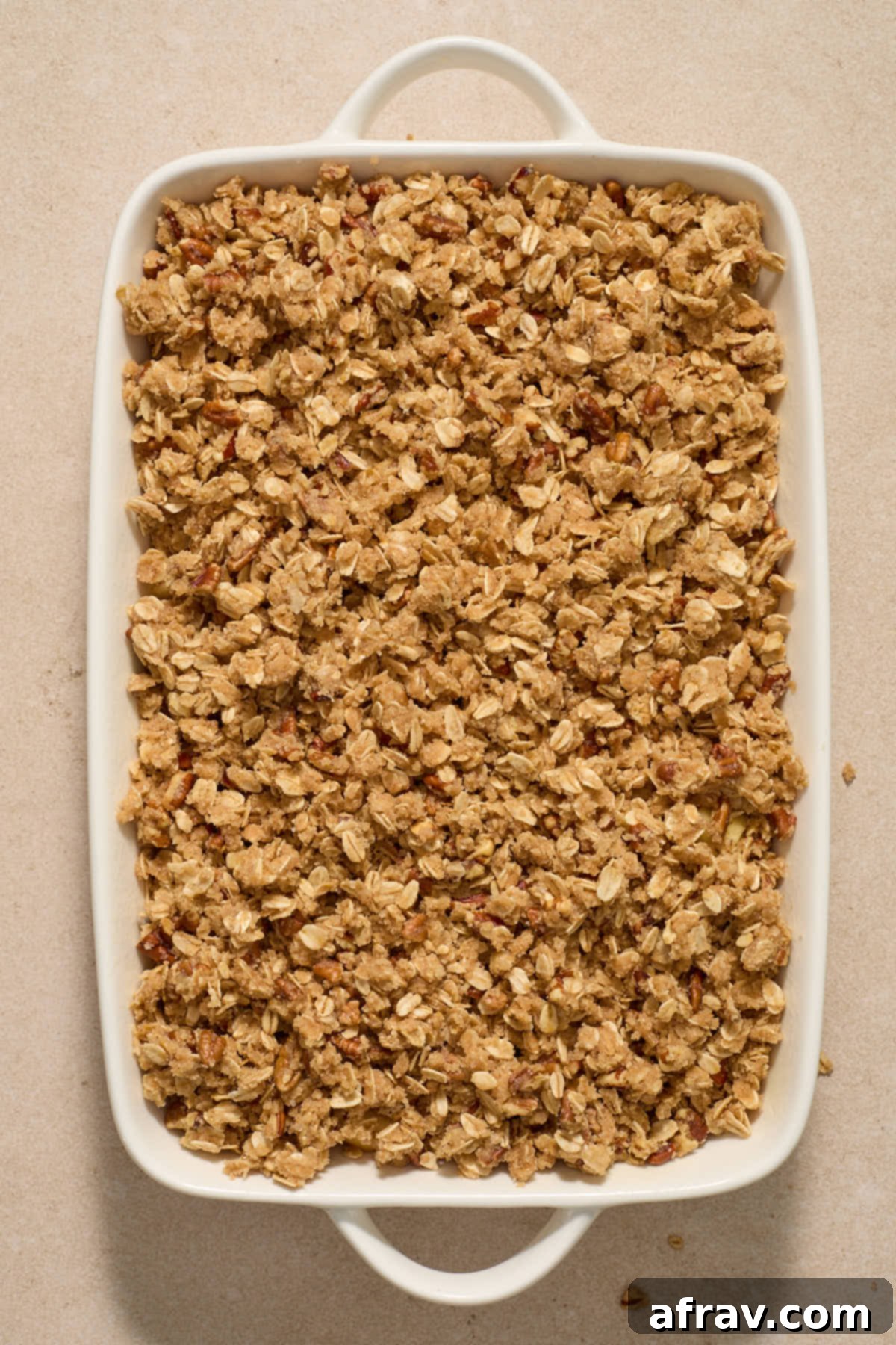 Gluten-Free Almond Flour Apple Pecan Crisp 8 Crisp topping layered generously on top of apples in a baking dish.