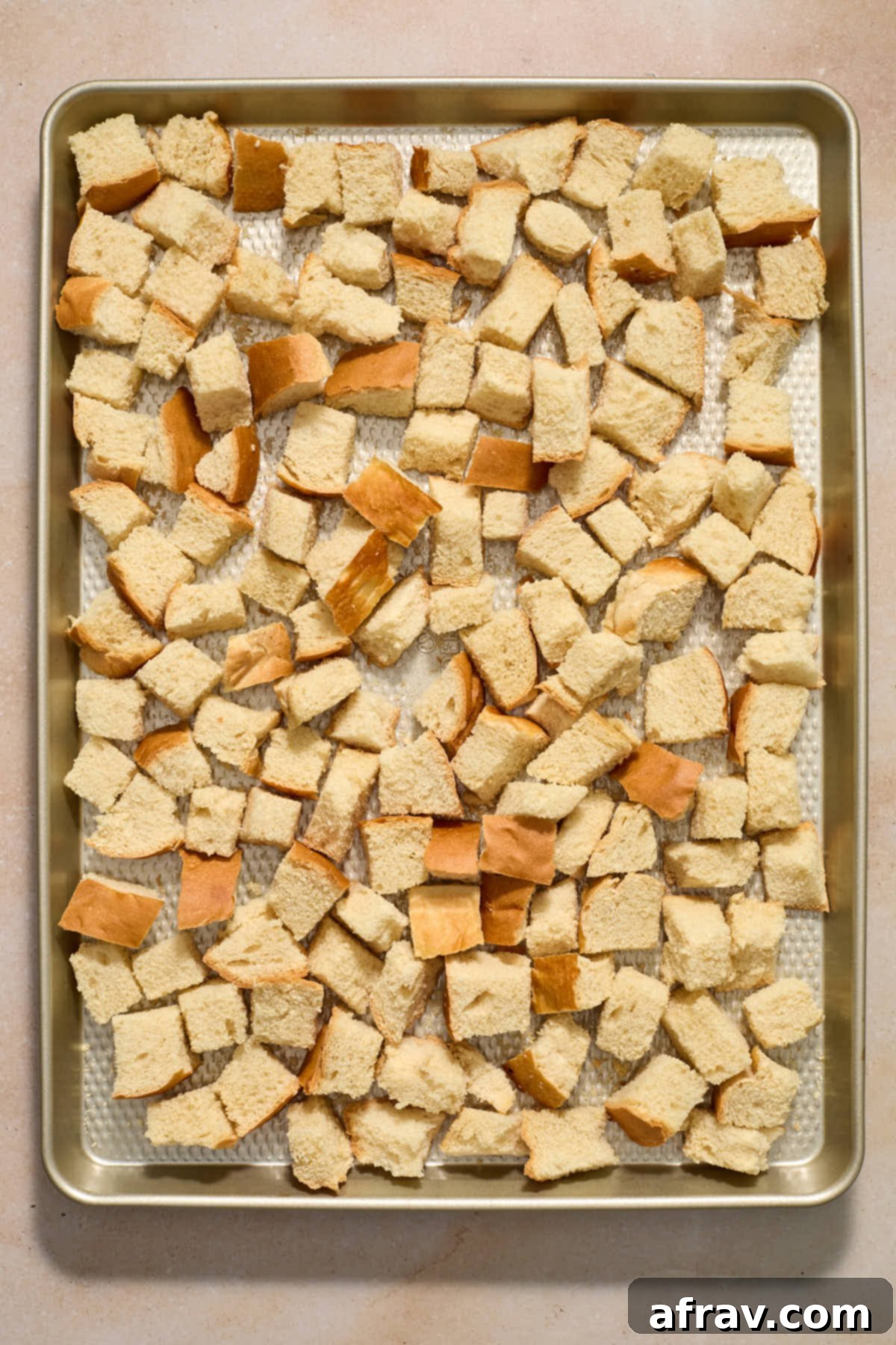 Festive Apple Cranberry Stuffing 4 Cubed bread dried out on a sheet pan.