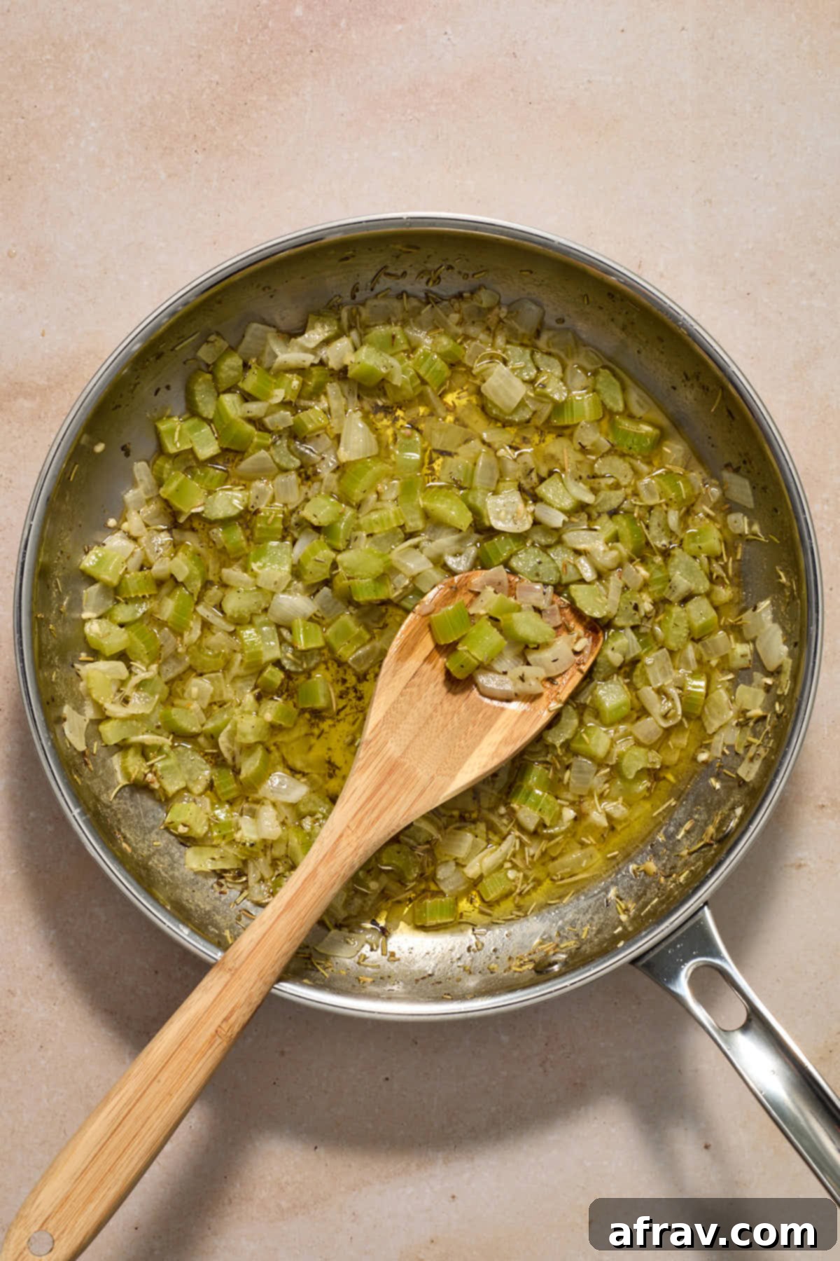 Festive Apple Cranberry Stuffing 6 Vegetable and herb mixture cooked in butter in a skillet.