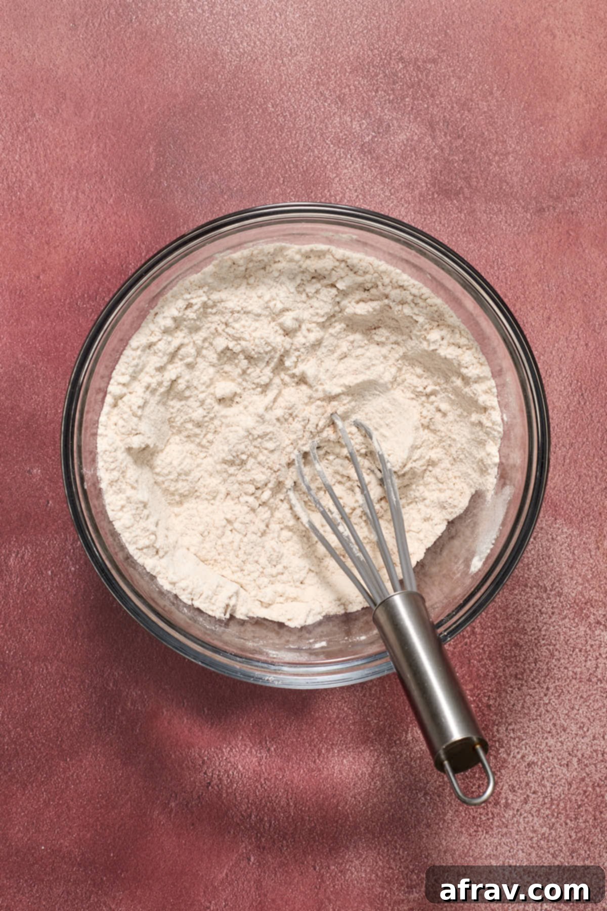 Dry ingredients whisked together in a glass bowl.