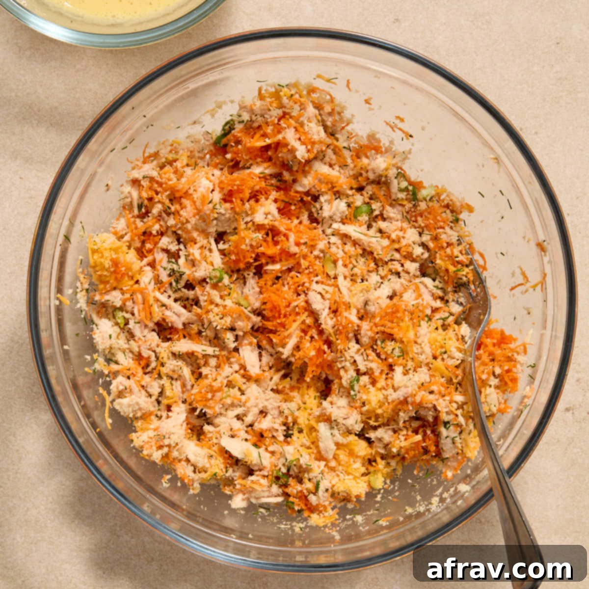 Air Fryer Tuna Cakes with Cheddar & Carrot Zest 4 Close up of tuna, carrot, cheese, panko crumbs, onion, and dill being stirred together in a bowl.