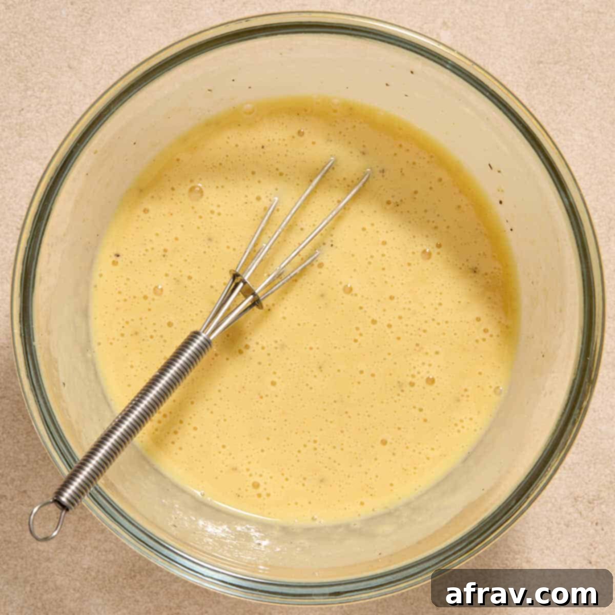 Air Fryer Tuna Cakes with Cheddar & Carrot Zest 5 Egg, mayo, mustard, lemon juice, and seasonings being whisked together in a bowl.