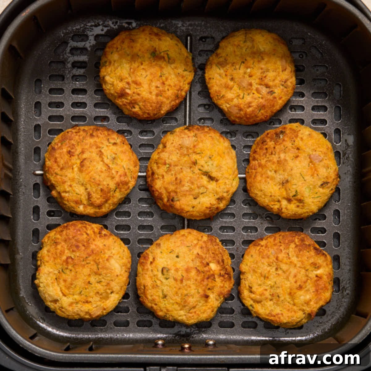 Air Fryer Tuna Cakes with Cheddar & Carrot Zest 8 Golden brown tuna cakes fully cooked in the air fryer basket.