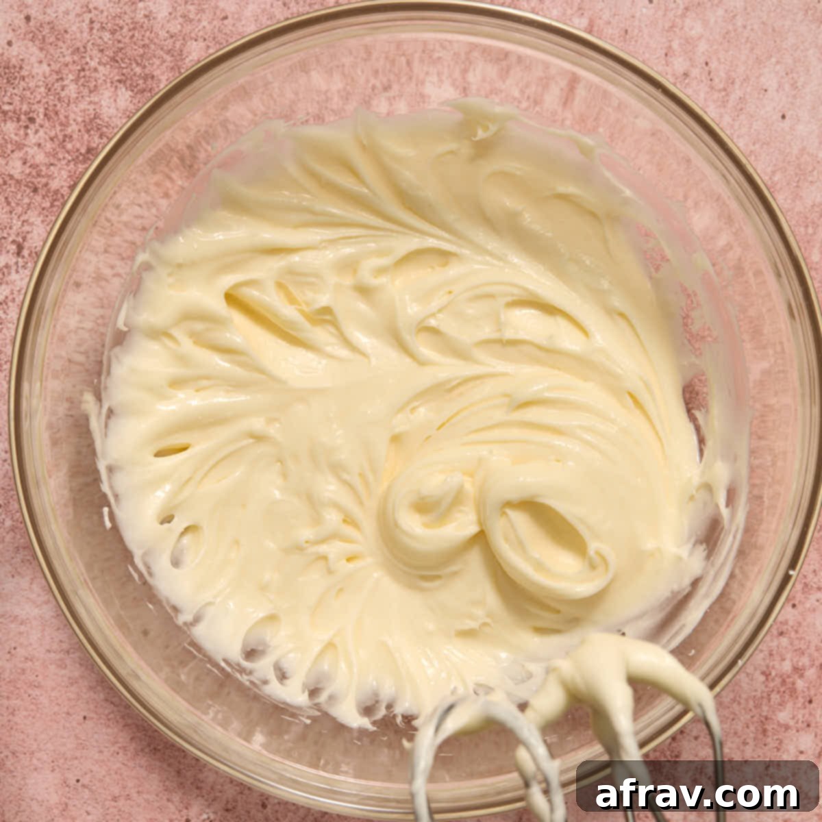 Almond Dream Bars: Chewy, Creamy, and Irresistibly Good 11 Cream cheese frosting whipped together in a glass bowl.