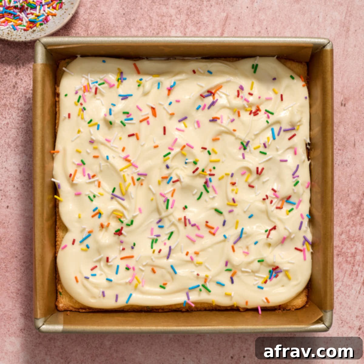 Almond Dream Bars: Chewy, Creamy, and Irresistibly Good 12 Sugar cookie bars in the pan and topped with frosting and sprinkles.