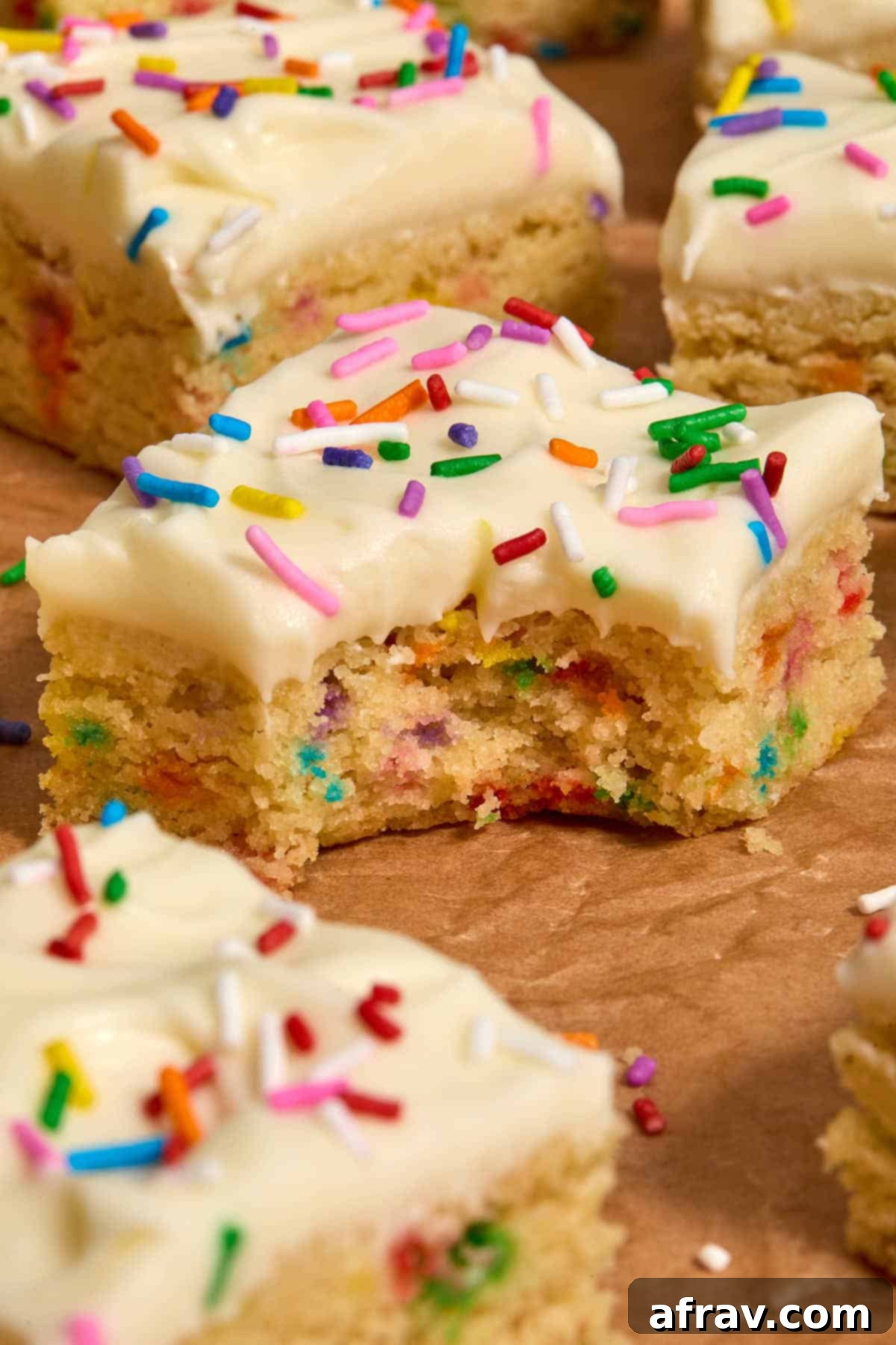Almond Dream Bars: Chewy, Creamy, and Irresistibly Good 13 Side view of a sugar cookie bar with a bite taken out.