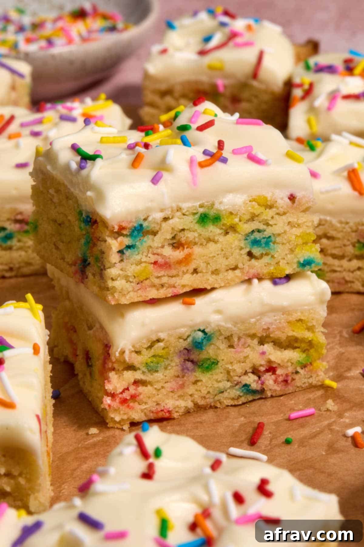 Almond Dream Bars: Chewy, Creamy, and Irresistibly Good 14 Stack of two sugar cookie bars with other bars surrounding them.