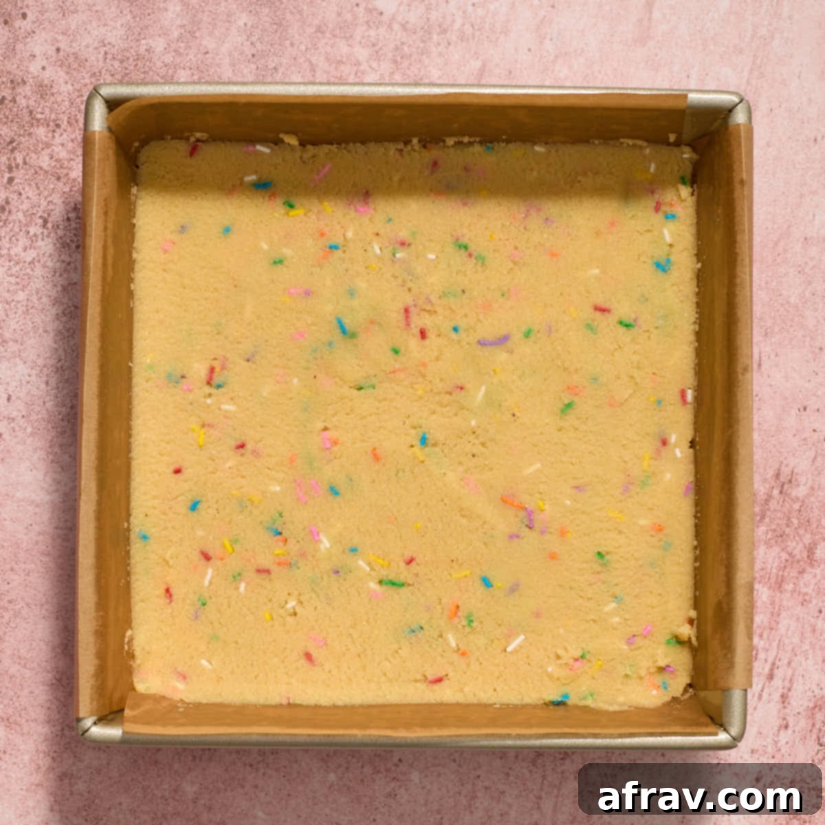 Almond Dream Bars: Chewy, Creamy, and Irresistibly Good 9 Cookie dough spread out in an 8-inch square pan.