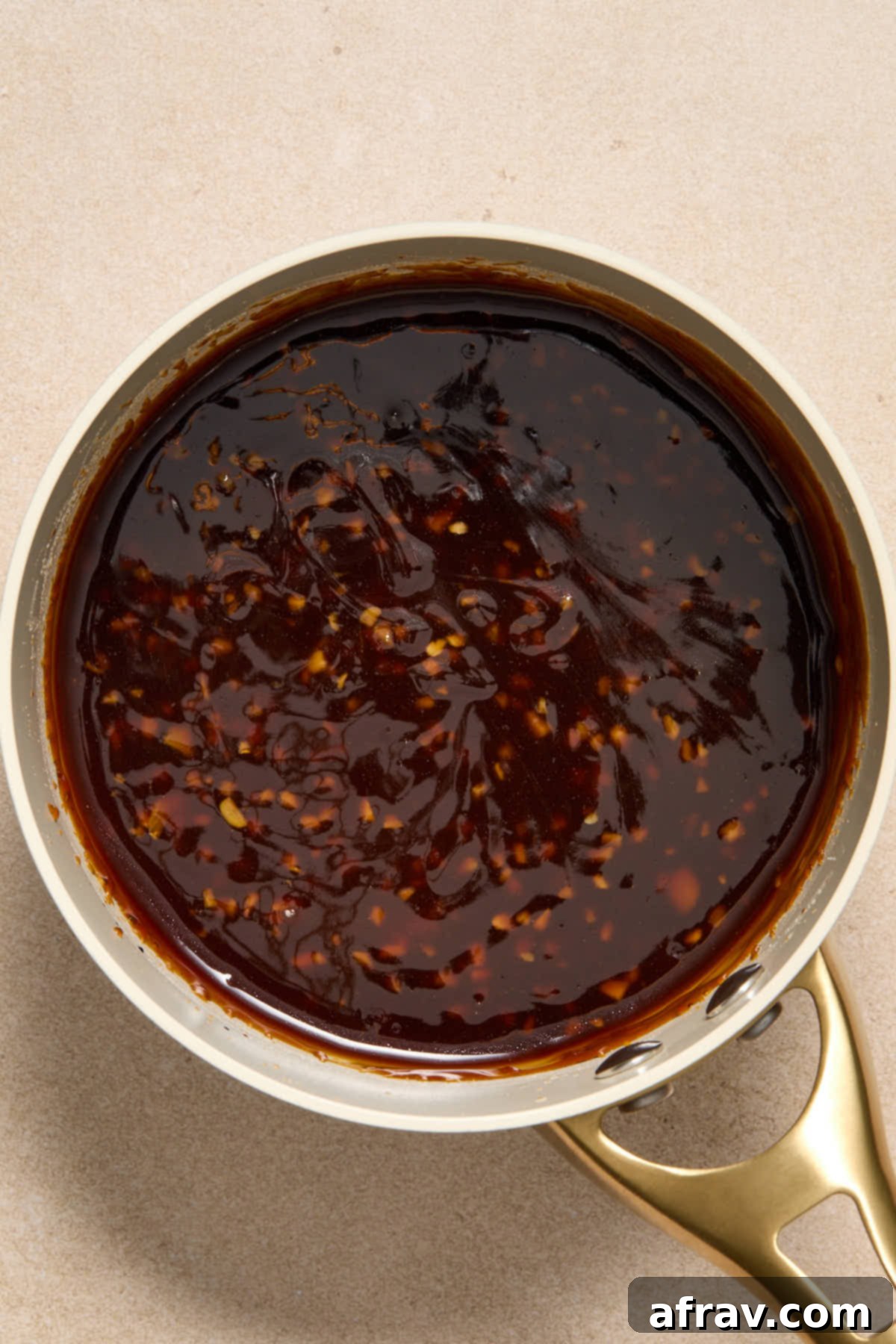 Honey Garlic Glazed Chicken Thighs: An Air Fryer Delight 7 Thickened honey garlic sauce in a small sauce pan.