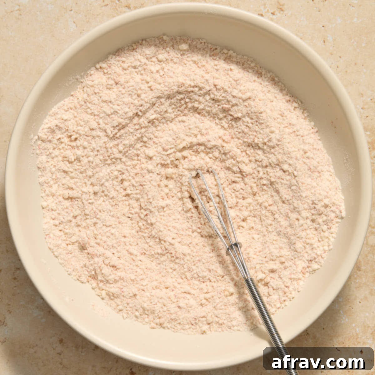 Garlic Parmesan Air Fryer Chicken Bites 5 Flour and parmesan coating mixed together in bowl with a whisk.