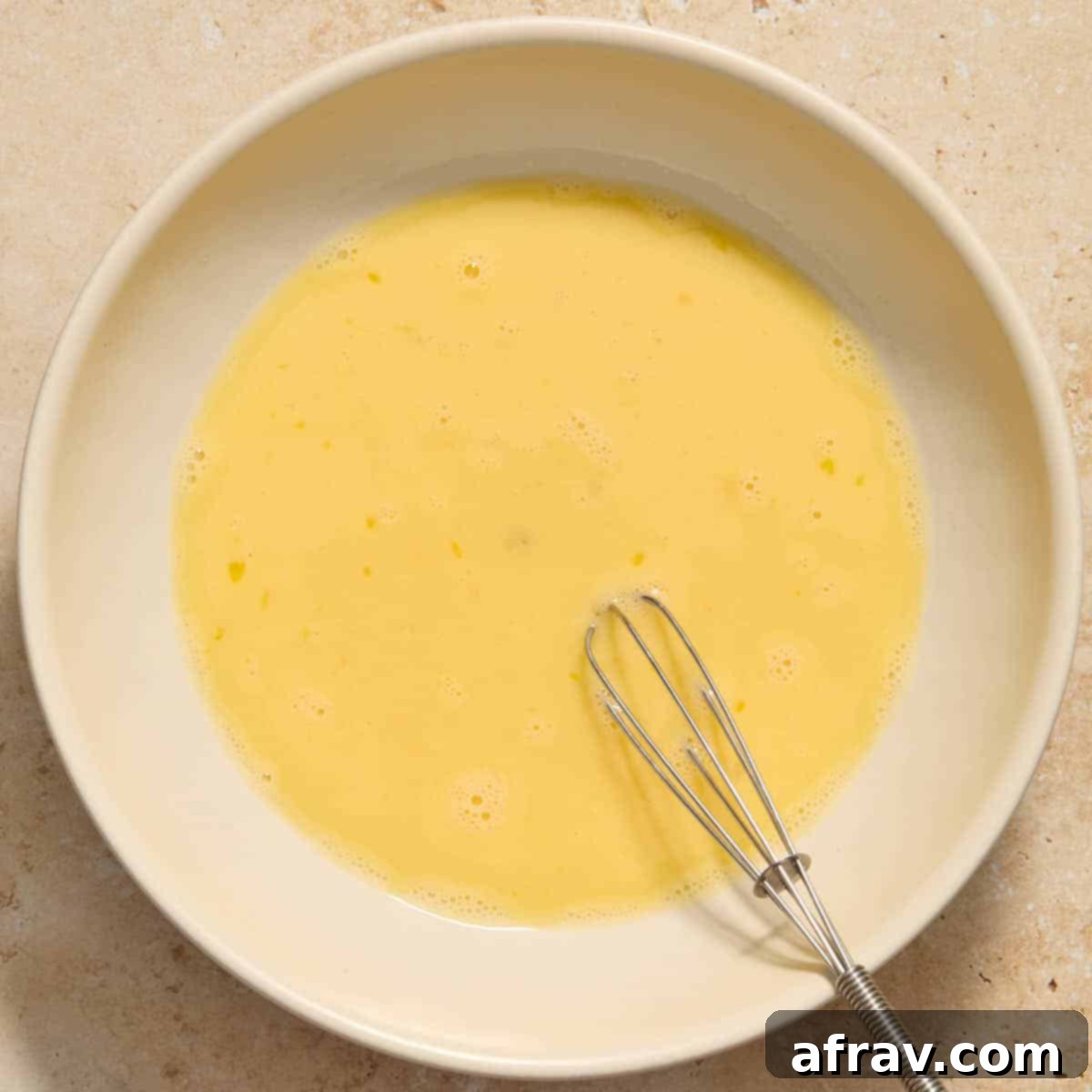 Garlic Parmesan Air Fryer Chicken Bites 6 Eggs and milk whisked together in a shallow bowl.