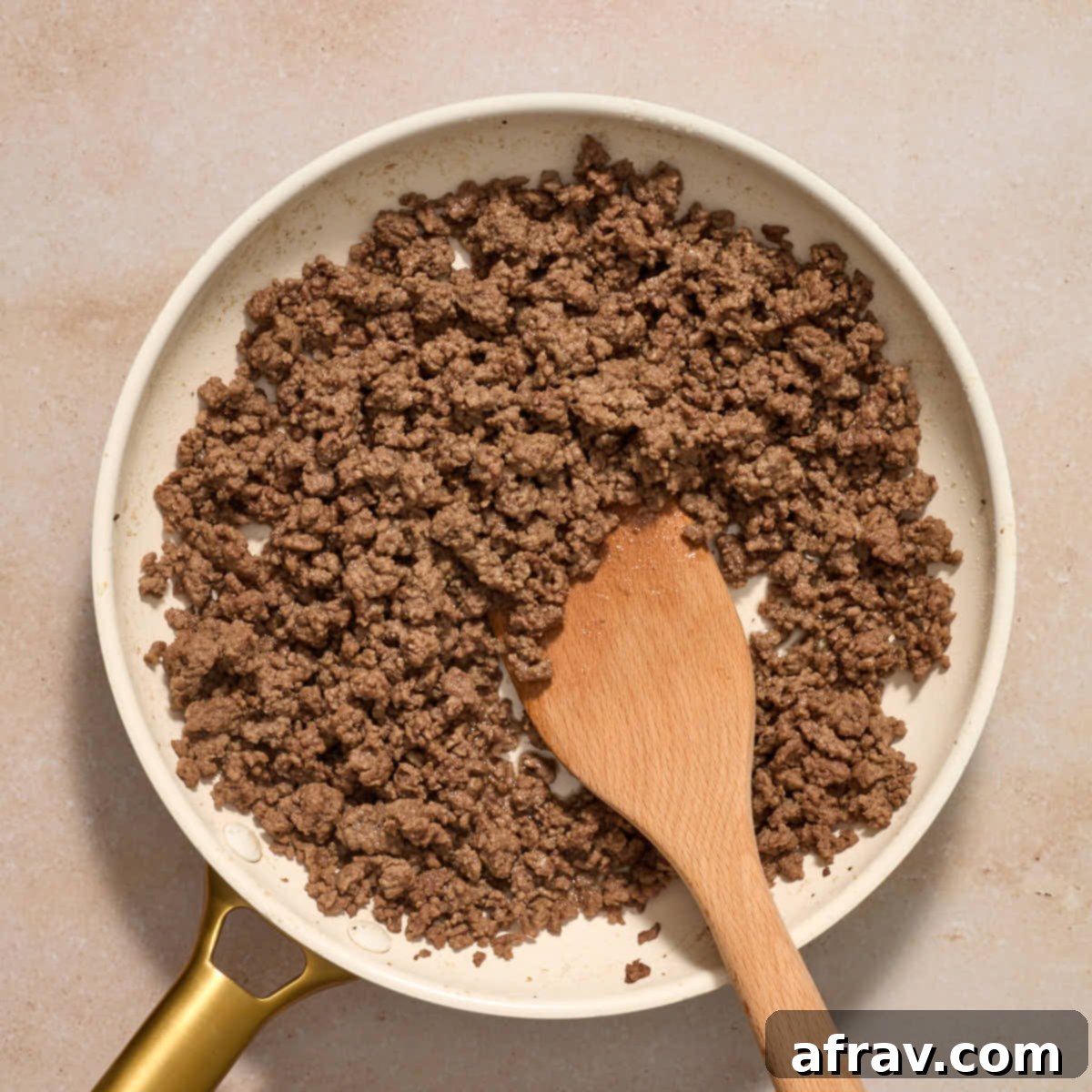 Air Fryer Mini Cheeseburgers 4 Ground beef cooked in a skillet.