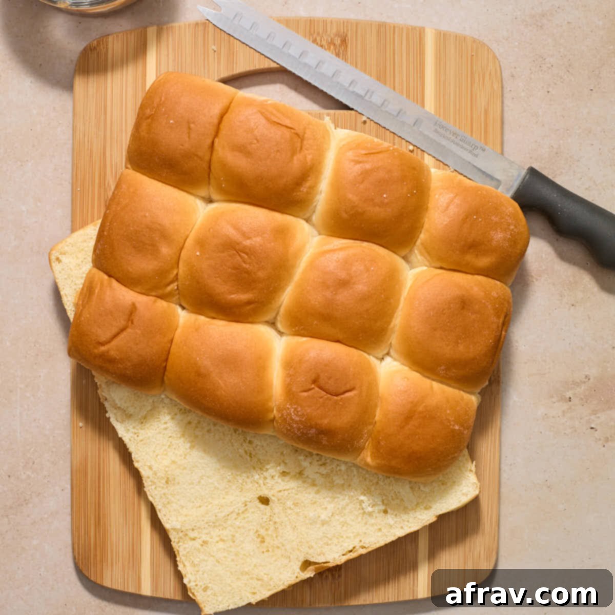 Air Fryer Mini Cheeseburgers 6 Package of sweet rolls cut in half horizontally on a wooden cutting board.